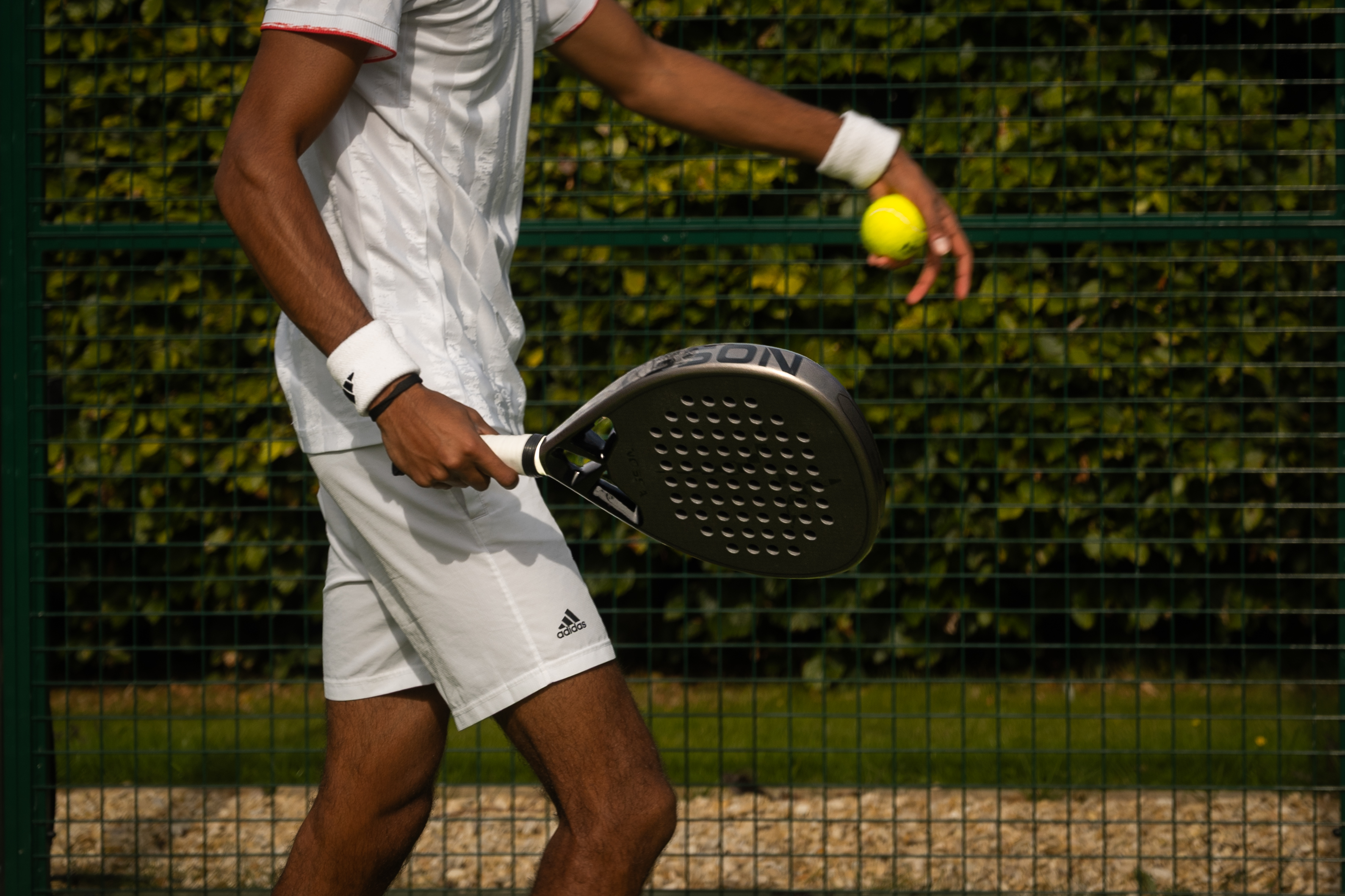 Player serving on a Nossa Padel court