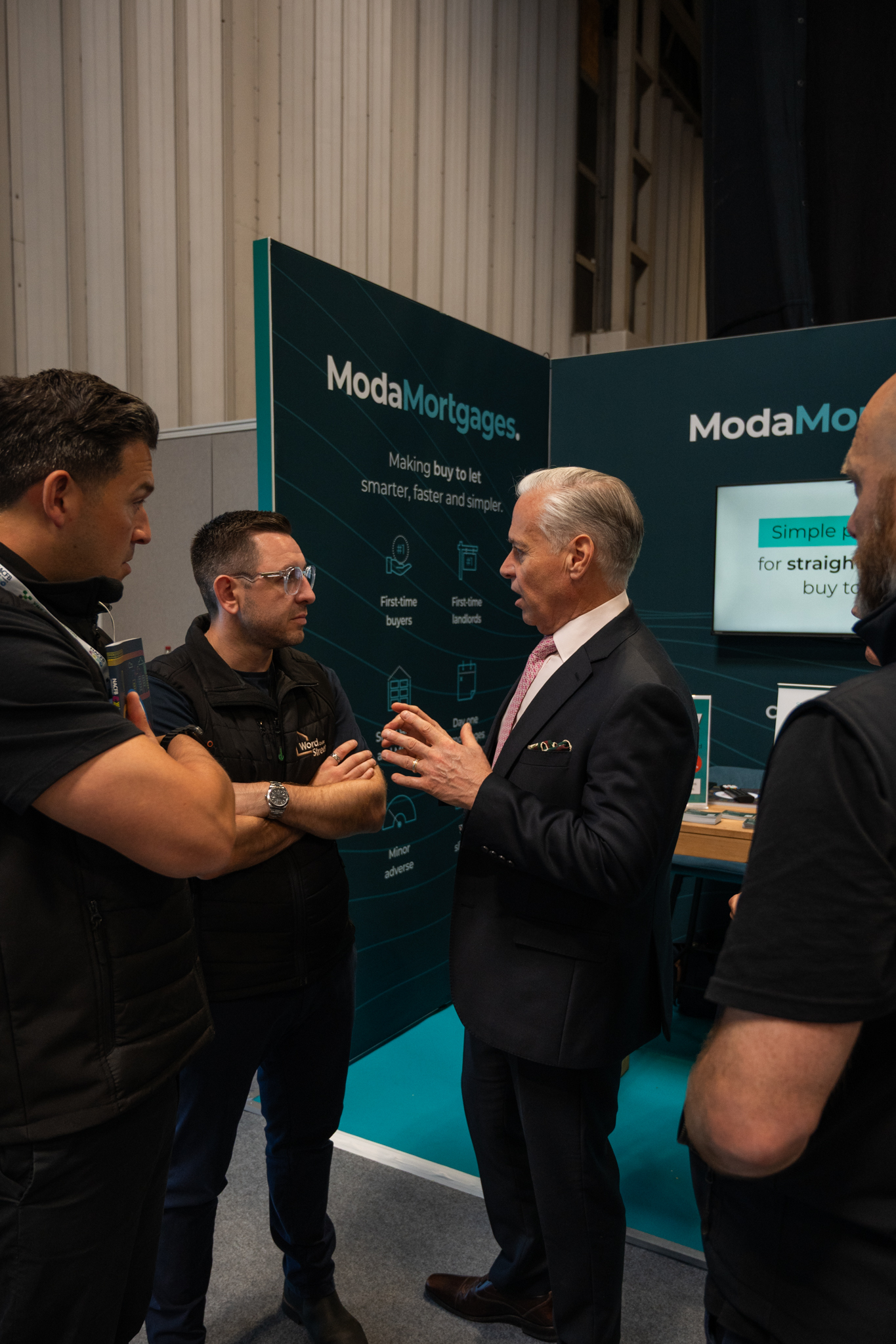 Word On The Street team speaking with a partner at a trade show stand