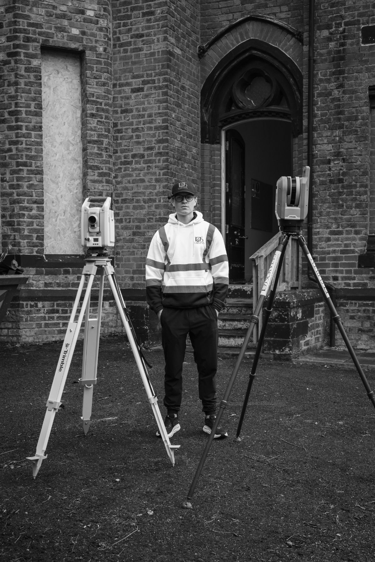 105 Surveys surveyor on site between two Trimble survey instruments